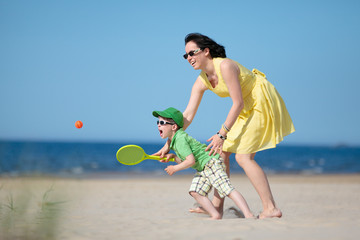 Young mother and son playing on the beach - 42445310