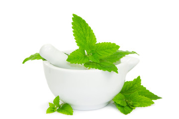 Lemon balm leaves with pestle and mortar