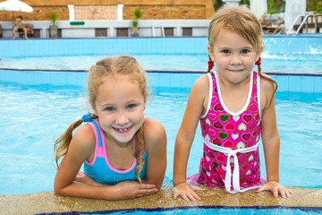 two little girls playing in the pool