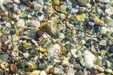 Seashore pebble over water