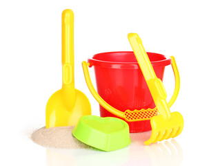 Children's beach toys and sand isolated on white