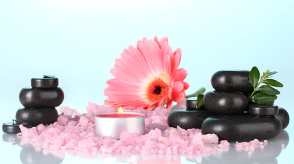 Composition of spa stones and bath salt on colorful background