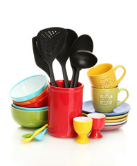 bright empty bowls, cups and kitchen utensils isolated on white