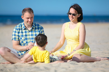 Family of three having fun on beach