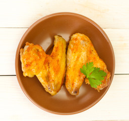 roasted chicken wings with parsley in the plate