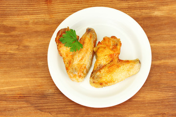 roasted chicken wings with parsley in the plate