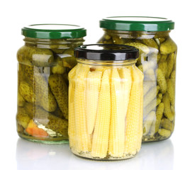 Jars of canned vegetables isolated on white