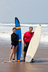 Two surfers on an ocean coast