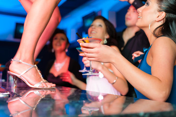 Frau in einem Club oder Bar tanzt auf dem Tisch