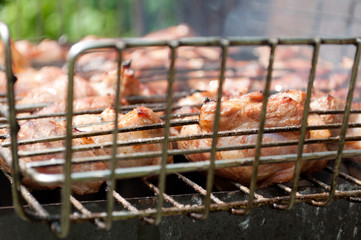 Grilling marinated meat on a charcoal grill