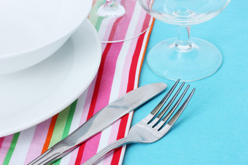 Table setting with fork, knife, plates, and napkin