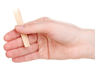 Toothpicks in hand isolated on white