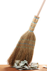 Broom sweep the dollars on white background