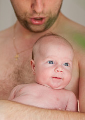 happy father holds his adorable 1 months old baby