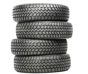Stack of four car wheel winter tires isolated
