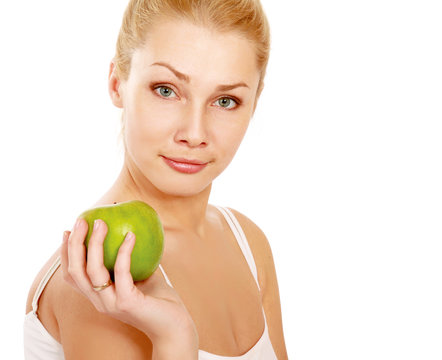 A portrait of beautiful young woman with a green apple