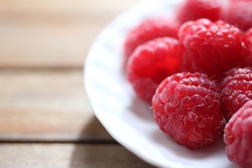 clean plate with fresh raspberries