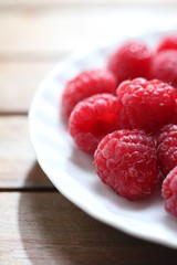 clean plate with fresh raspberries