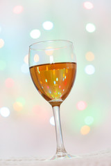 Glass of White Wine with Lights Background