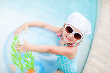 Adorable little girl at swimming pool