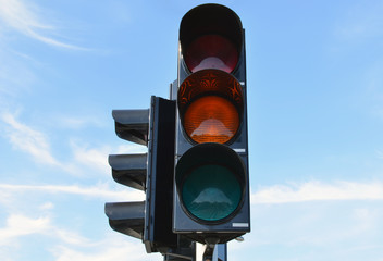 Yellow color traffic light blue sky in background
