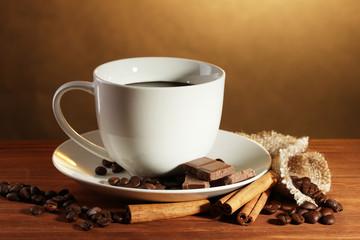 cup of coffee and beans, cinnamon sticks and chocolate
