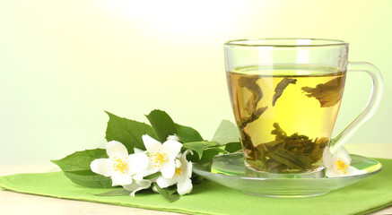 cup of green tea with jasmine flowers