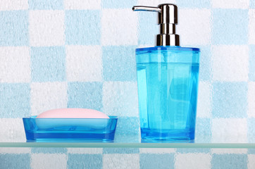 Bath accessories on shelf in bathroom