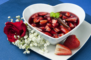 strawberries with red wine, cinnamon and brown sugar on a colore
