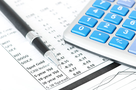 pen and calculator on business paper background