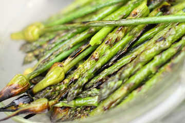 Grilled garlic spears and asparagus in a bowl.