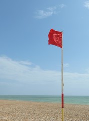Fototapeta premium Red warning flag at beach