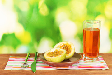 Green passion fruit in the plate on bright green background