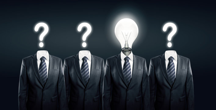 Businesssman with idea standind between other businessmen
