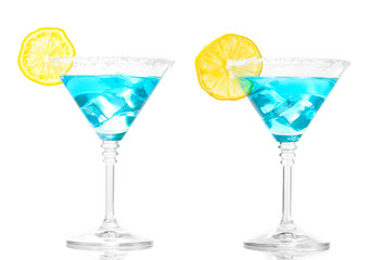 Blue cocktail in martini glasses isolated on white