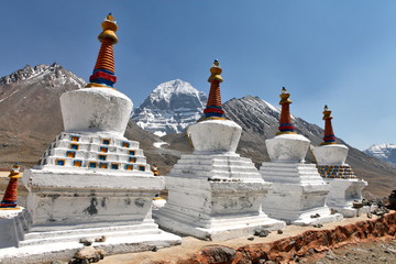 Buddhist statues in Tibet with holy Mount Kailash background