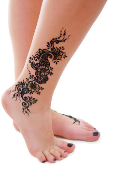 henna being applied to leg