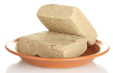 tasty halva in the plate isolated on white close-up