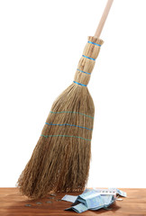 Broom sweep the euro on white background close-up
