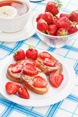 French toasts with powdered sugar and a strawberry