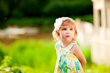 Portrait of a little girl outdoors in sunny day