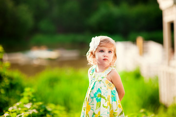 Portrait of a cute little girl in sunny summer day