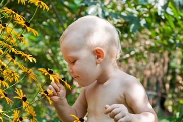 Baby smells the flowers