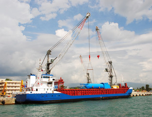 Fototapeta premium The cargo ship under unloading in sea port