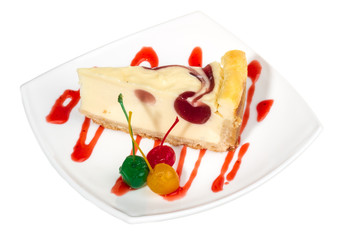 Closeup of a slice of cherry cheesecake on a white background