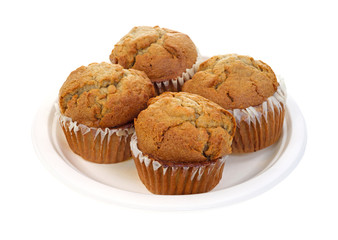 Four apple spice muffins on paper plate