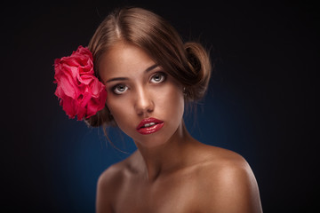 Beauty face of the young woman with flower