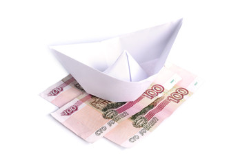 Paper boat on the money isolated on a white background