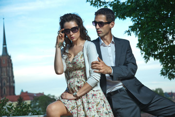 Young, smiling couple wearing sunglasses
