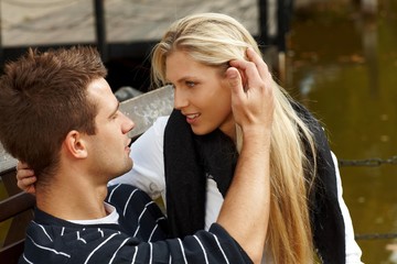 Young couple kissing by lake
